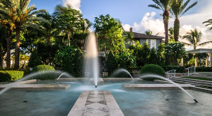 A stone fountain surrounded by greenery on the chapel grounds