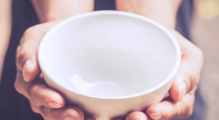 hands holding an empty bowl