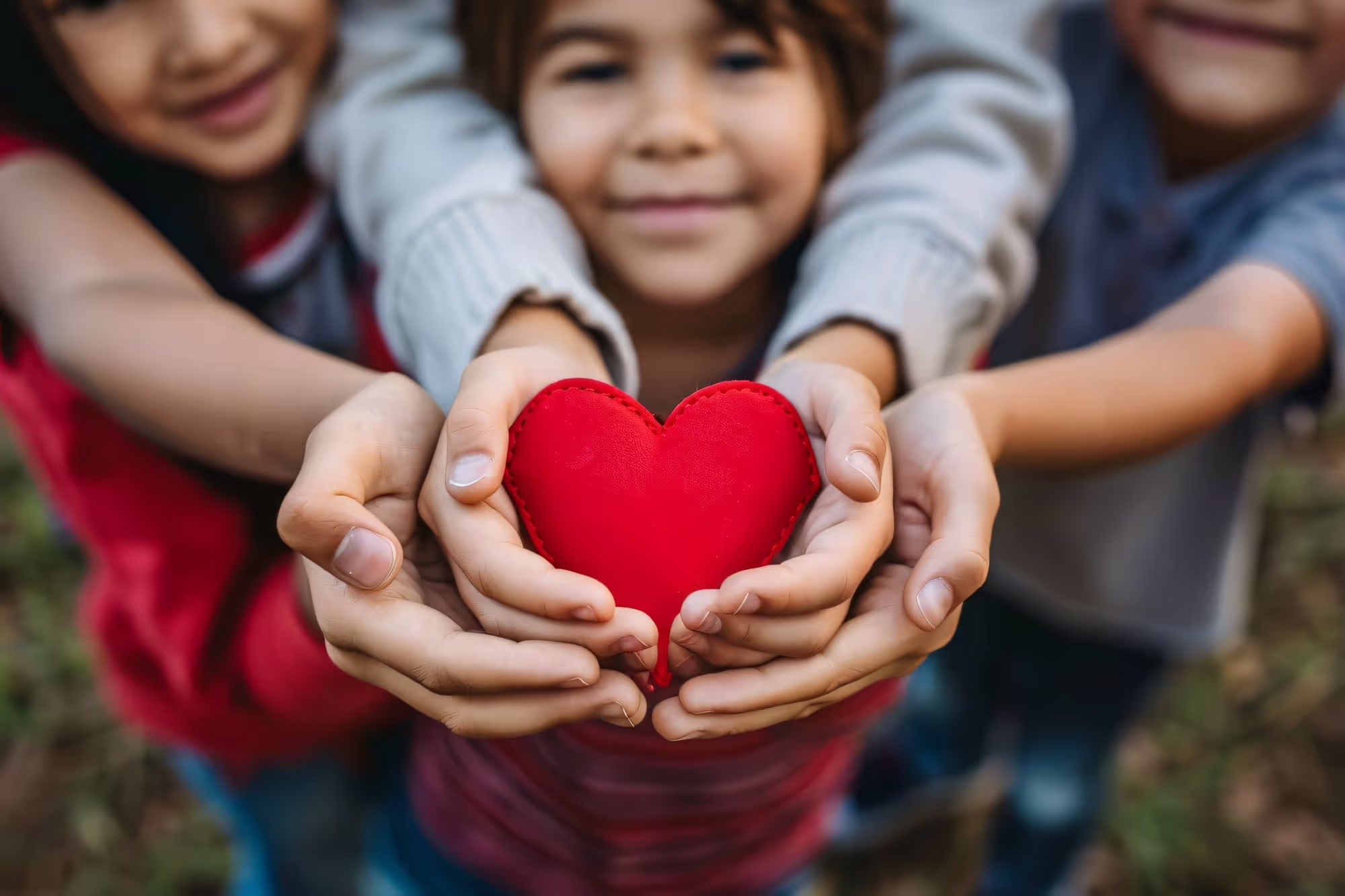 Kids holding a big heart 