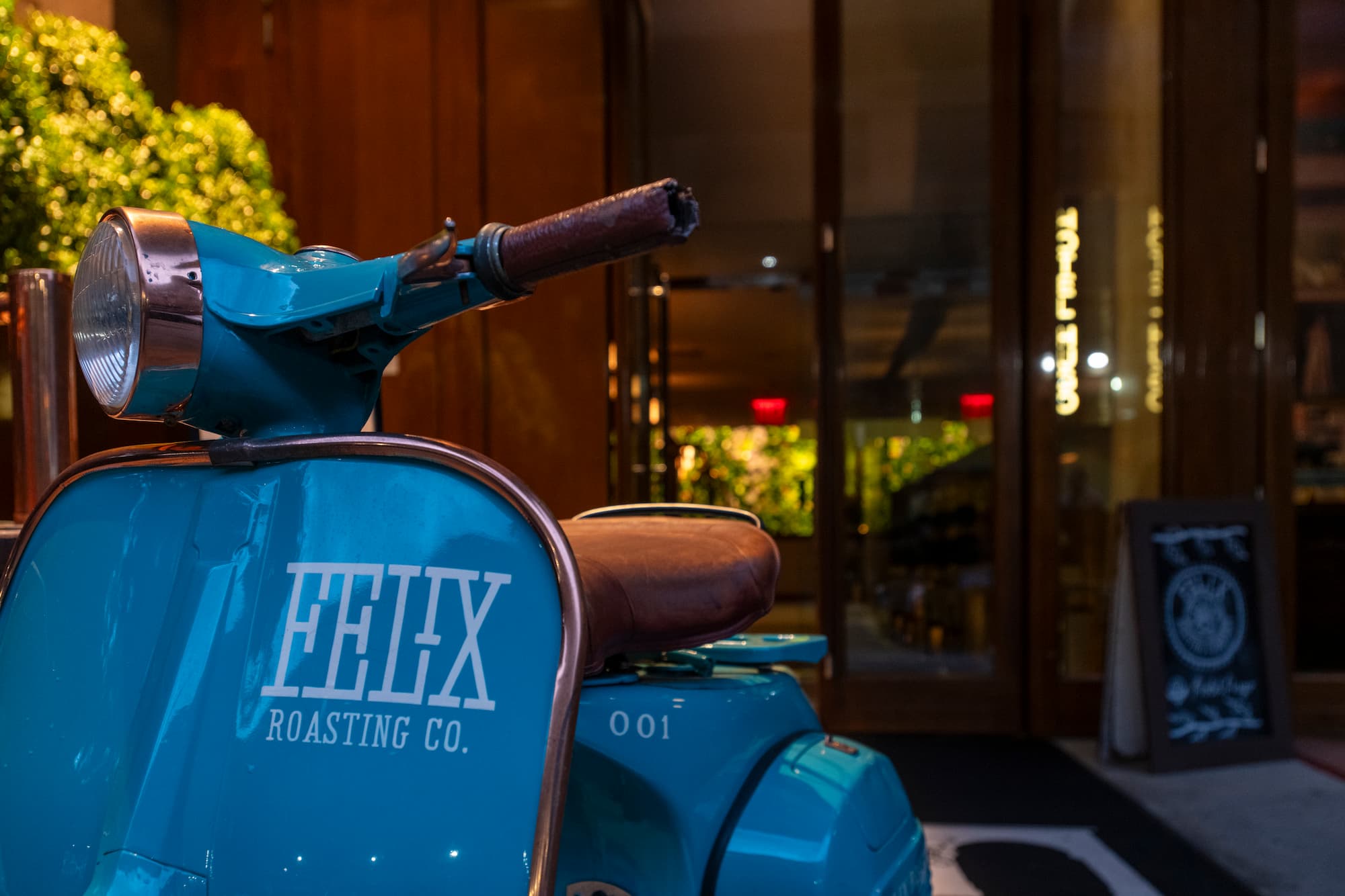 Entrance of Hotel Hugo and its iconic blue Felix Roasting Co. scooter.