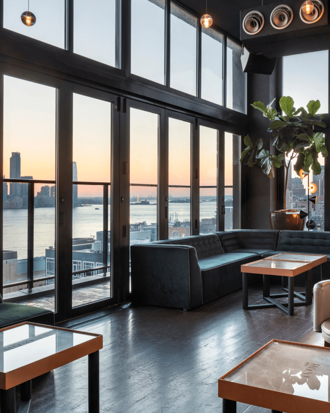 Hotel Hugo neon sign glowing at night in SoHo NYC with urban backdrop