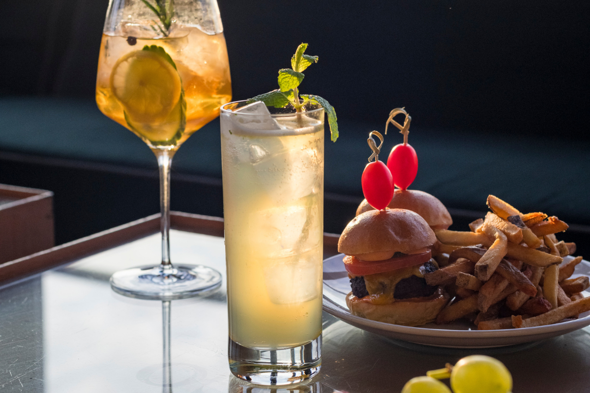 Gourmet bites and cocktails near Hotel Hugo SoHo with skyline views.
