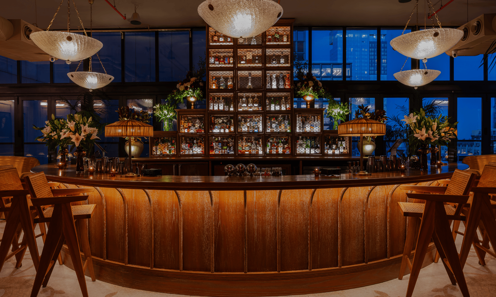 Rooftop Hugo Bar with elegant seating and warm lighting.