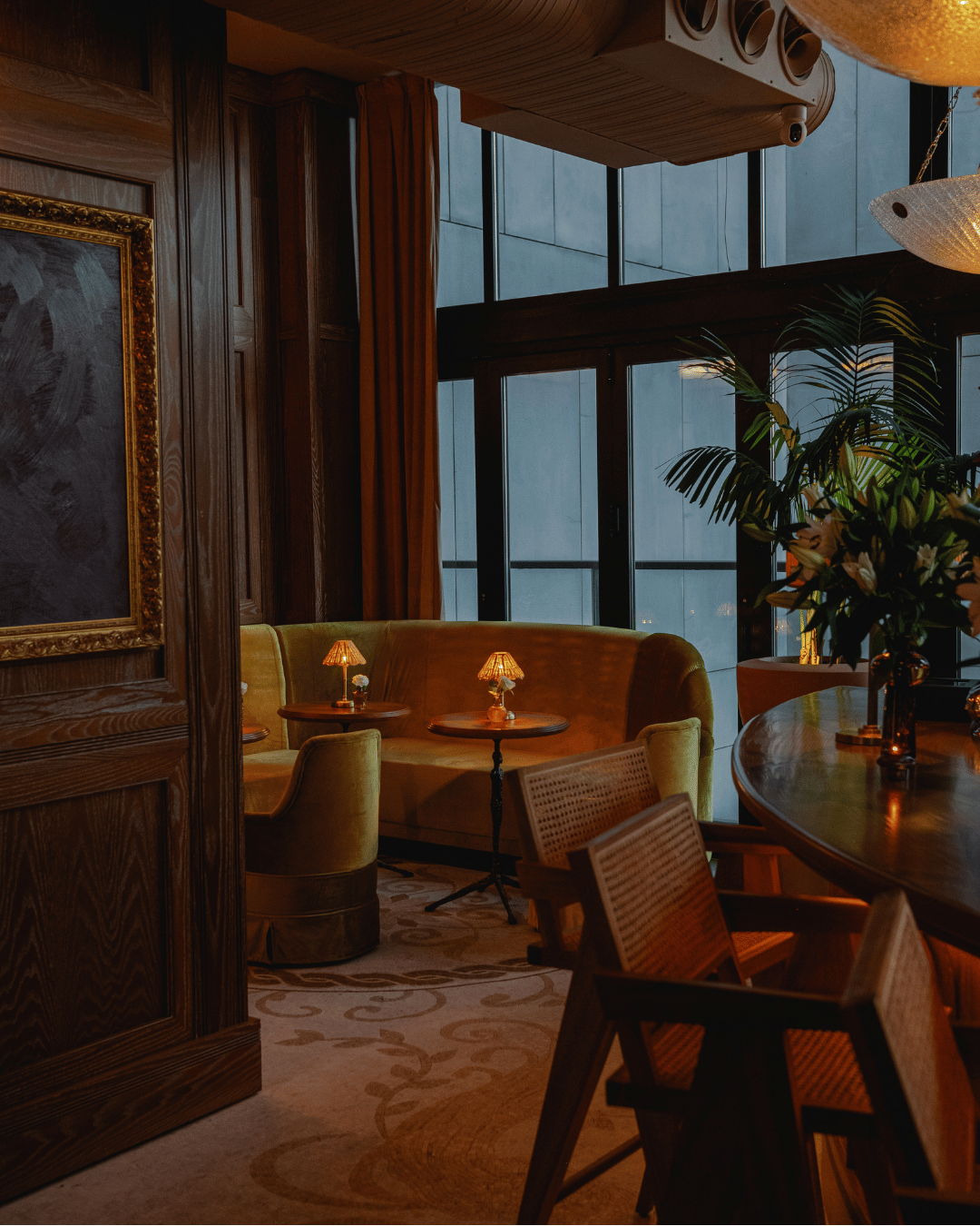 Hotel lounge with large windows overlooking the New York skyline.