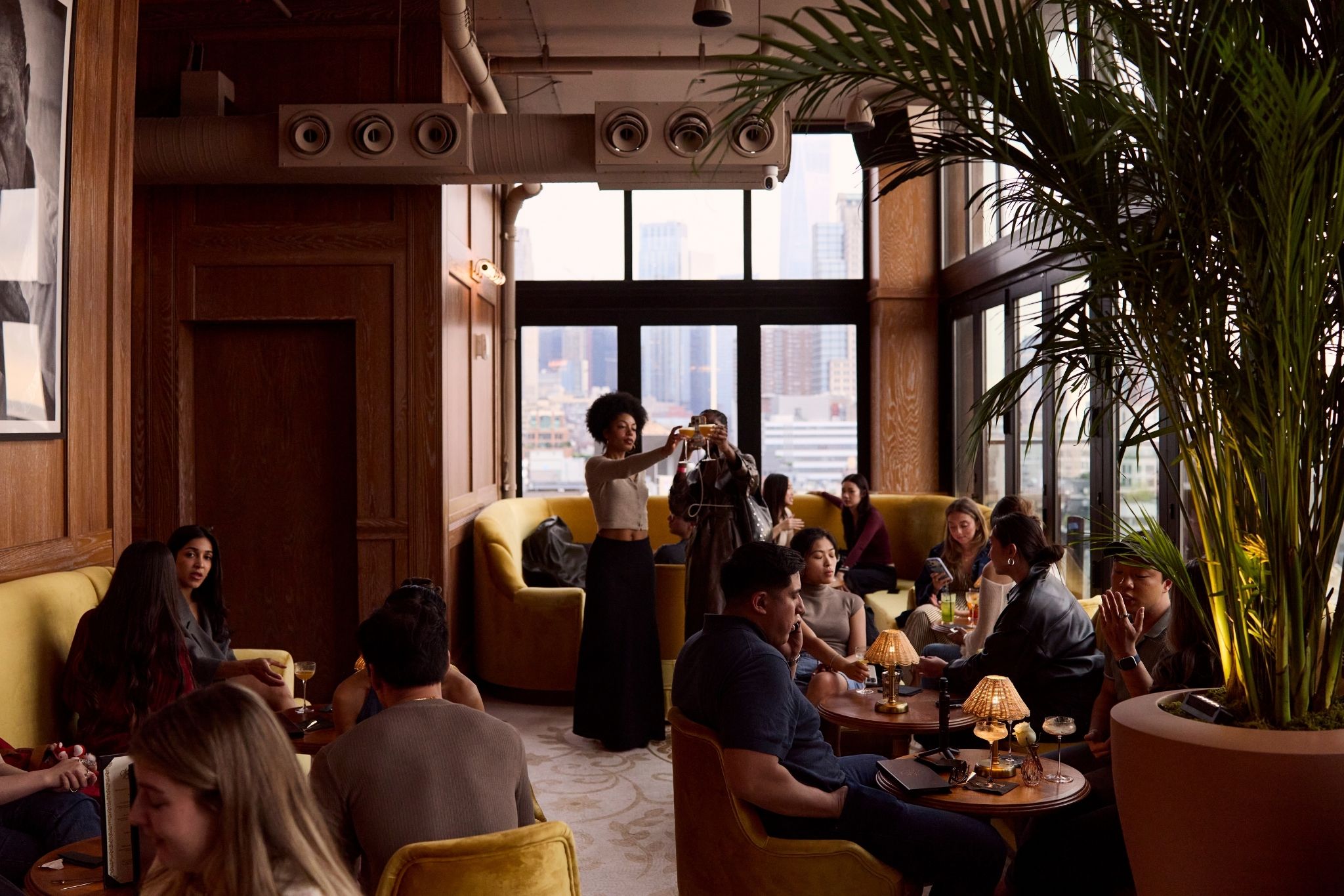Bar Hugo NYC Instagram post showing guests socializing at the rooftop bar