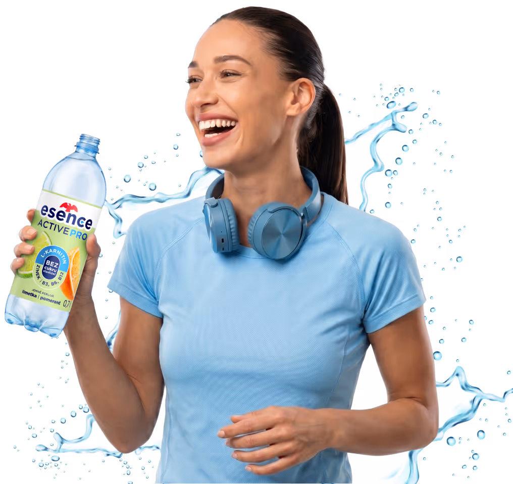 Woman in blue shirt holding Esence Active Pro drink with headphones around her neck