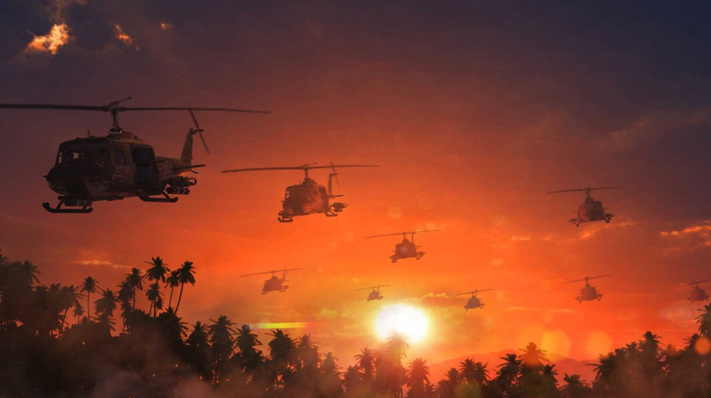 Military helicopters flying over palm trees at sunset