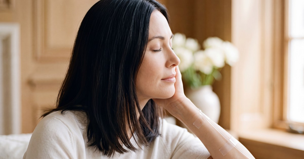 Woman receiving an NAD+ infusion in a relaxed setting, with the IV access point visible on her forearm