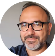 Middle-aged man with glasses and beard in professional headshot portrait