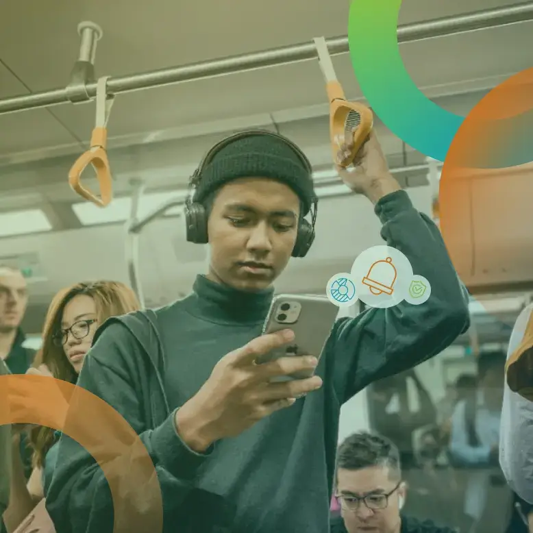 Man on subway looking at his phone with IDIQ products on it