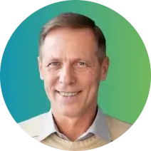 A middle-aged man with short, light brown hair, wearing a light-colored collared shirt and a beige sweater. He is smiling and positioned against a blue to green gradient background, representing the professionalism associated with credit management.