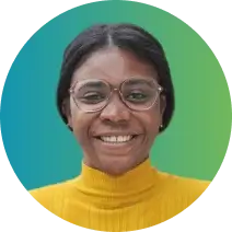 A person with short black hair, wearing glasses and a yellow turtleneck, smiles at the camera. The background is a gradient of blue to green, subtly emphasizing a focus on credit management.