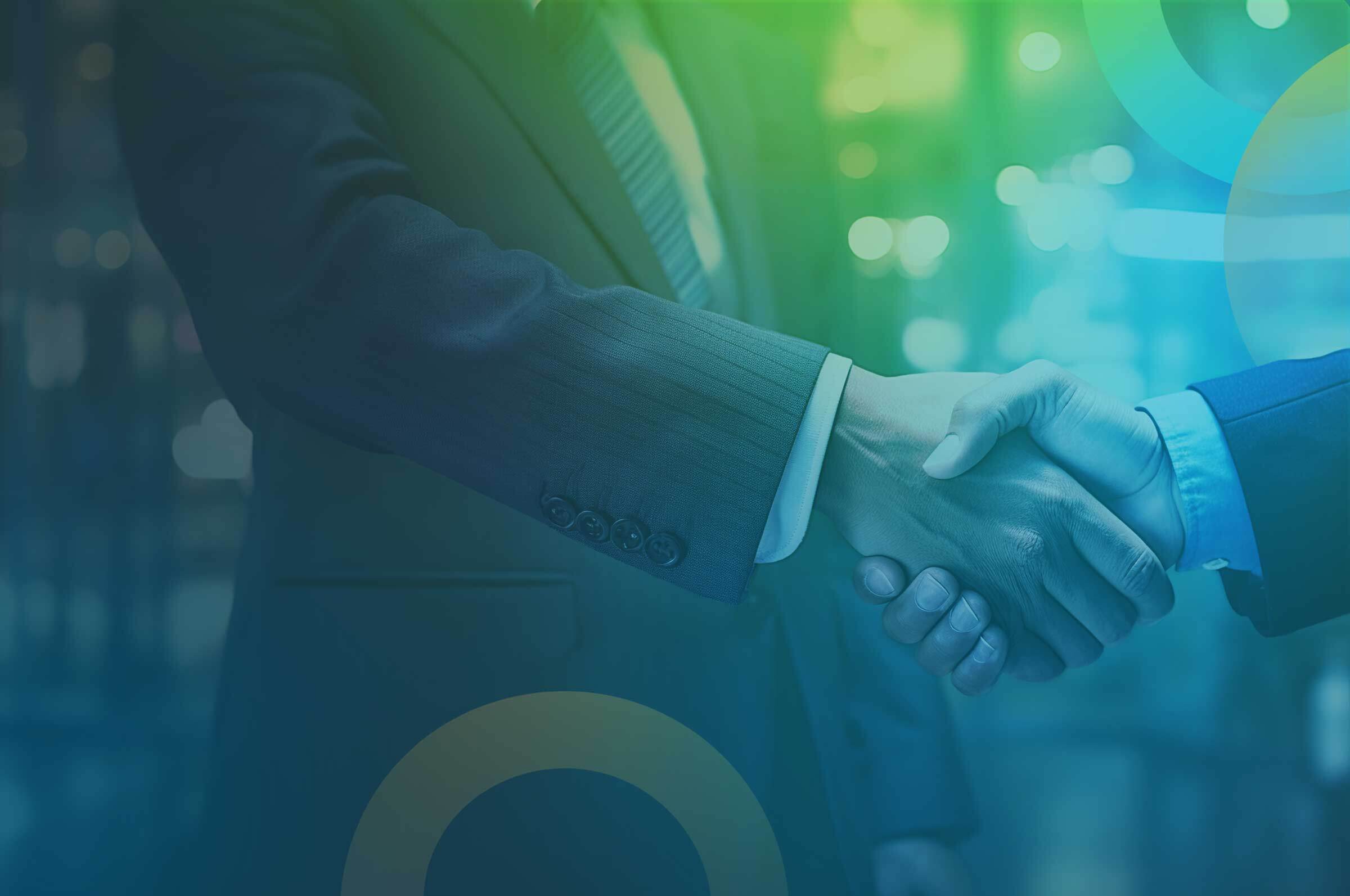 Two people in business suits shaking hands, symbolizing a business agreement or partnership. The background is blurred with a blue and green gradient, giving a professional and modern feel to the image, indicative of discussions about employee benefits.