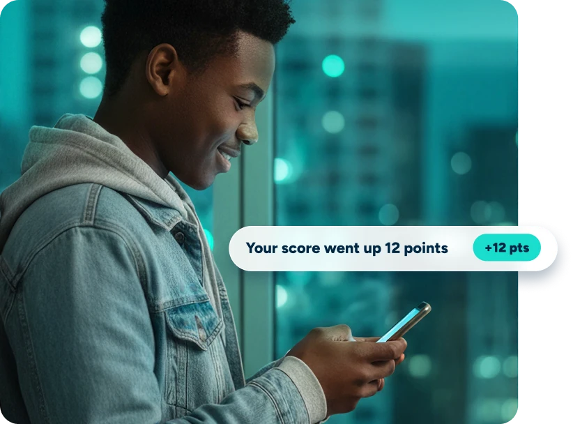 Young man with a turquoise toned background looking at his phone smiling while seeing an alert from Acru that says Your score went up 12 points