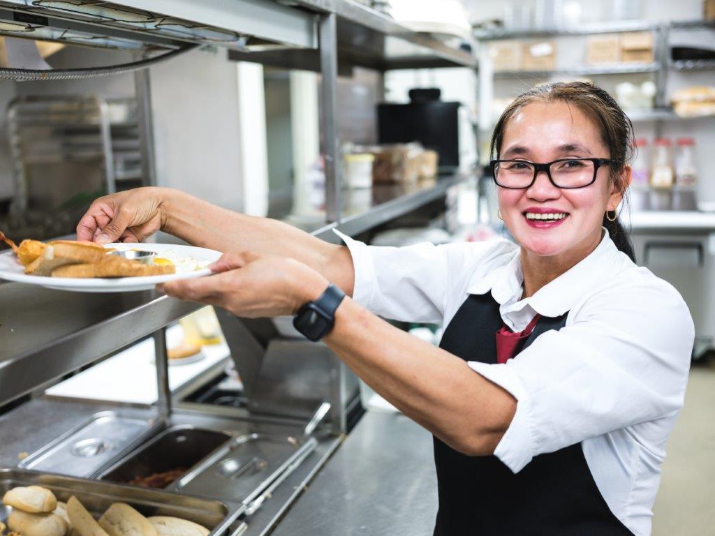 chef creating meals in a senior living community 
