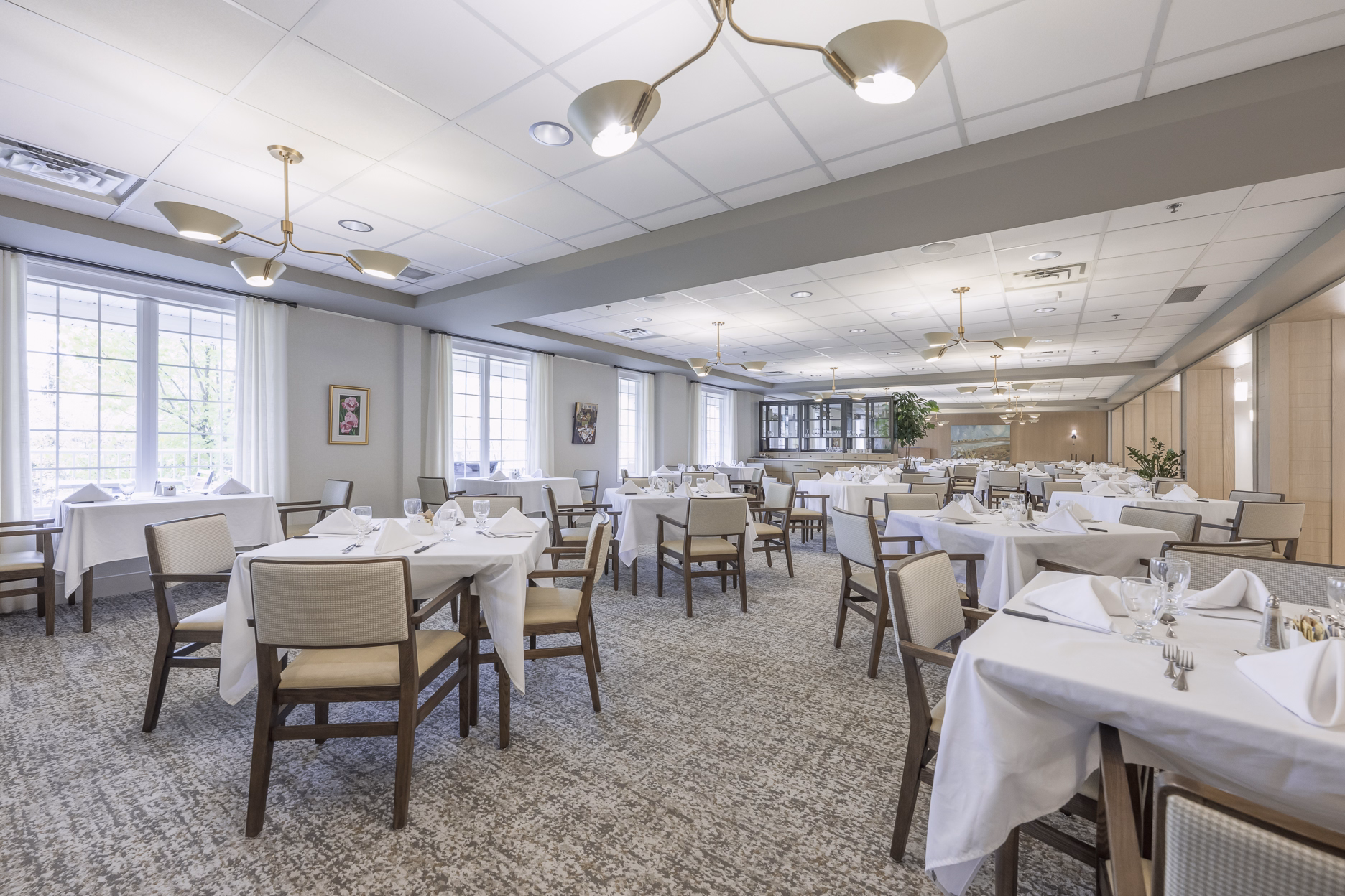 The dining room at United Active Living's Garrison Green community in Calgary, with tables set for a meal