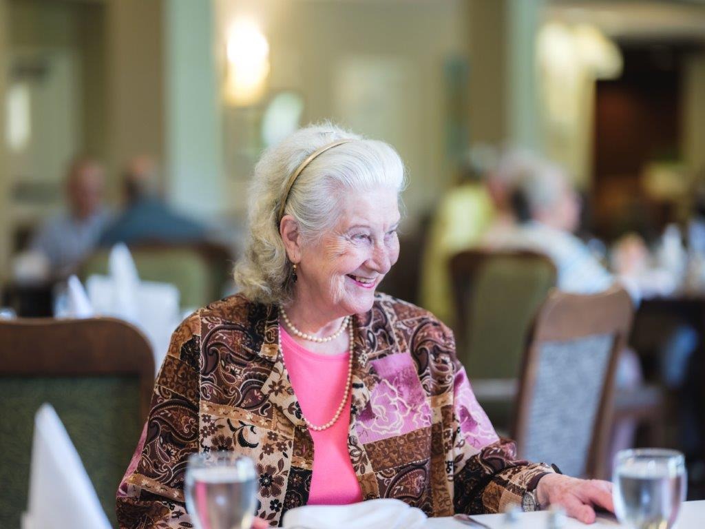 older woman smiling in senior living