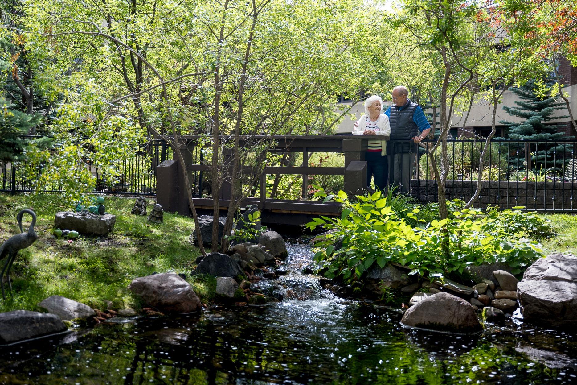 two happy seniors in a beautiful garden in a retirement community in Calgary