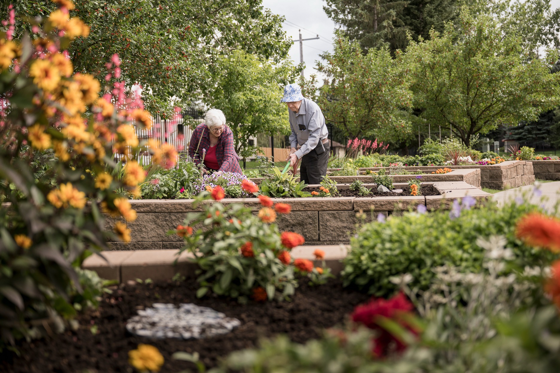 2 seniors gardening in senior community