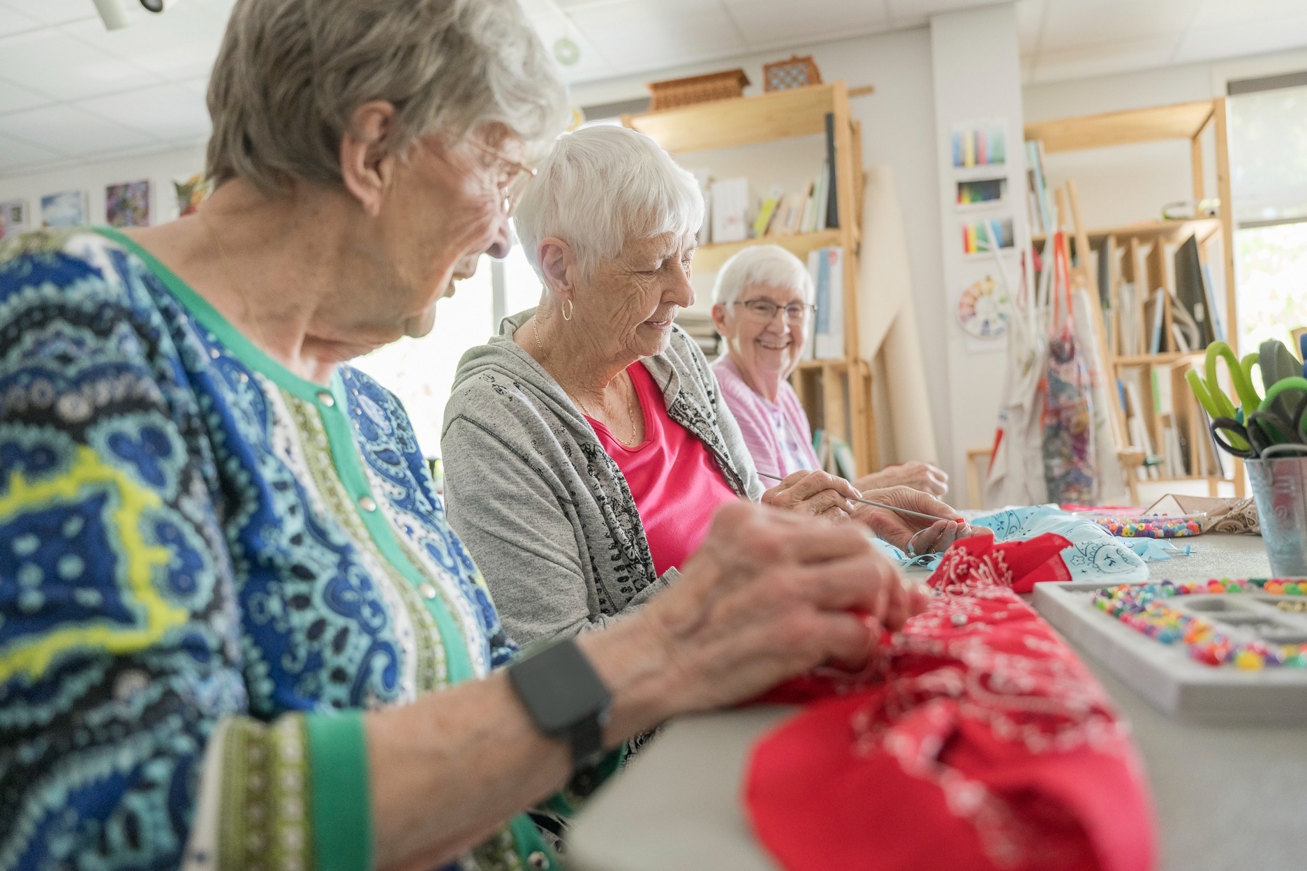 group of ladies talking and crafting in a retirement living activity