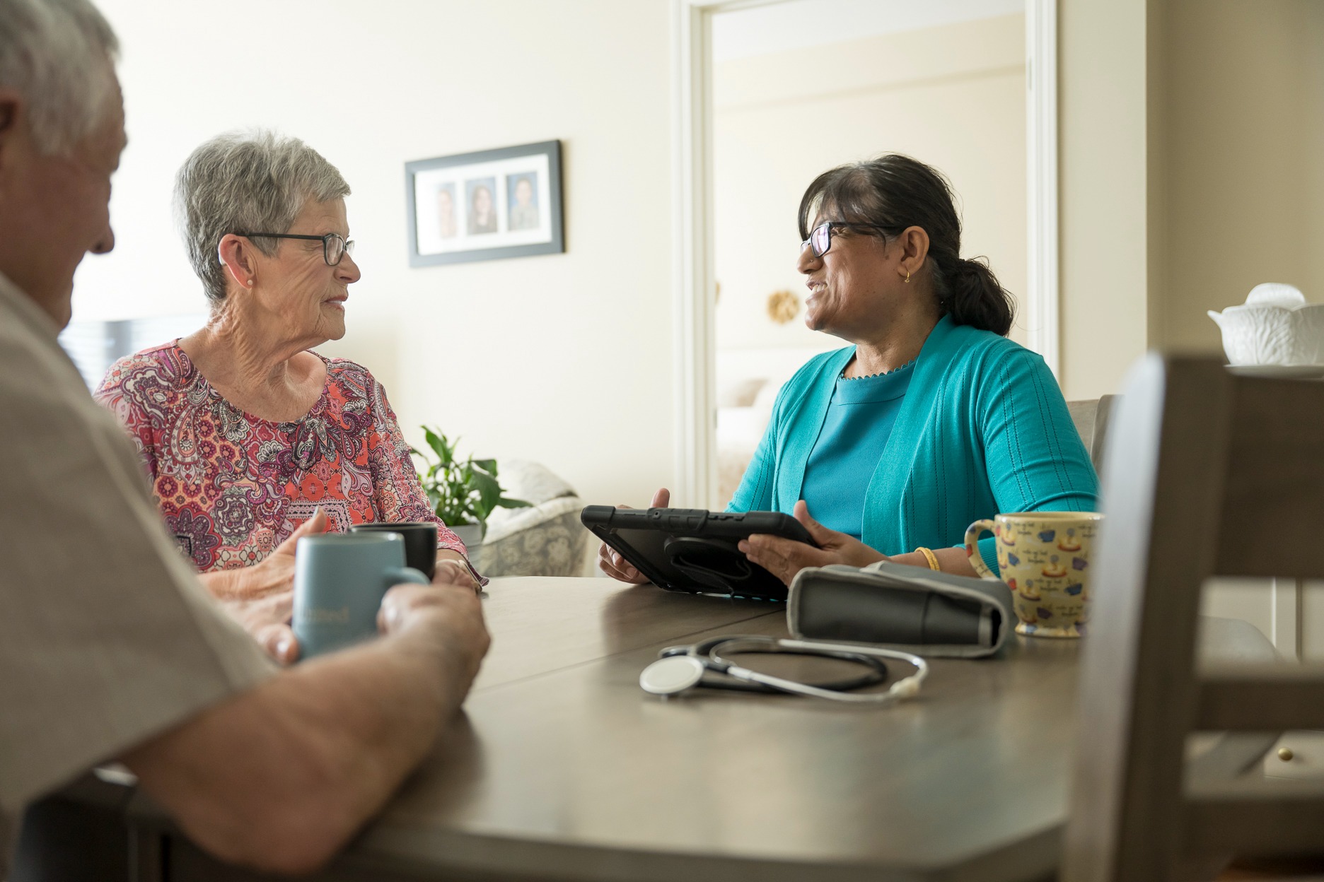 Senior living employee discussing senior living options with older couple
