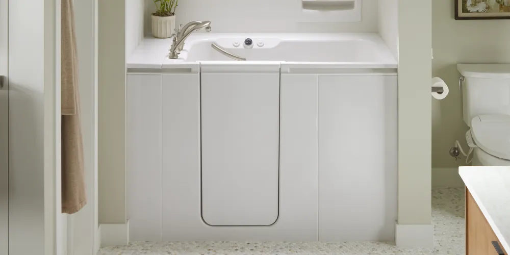 A Kohler walk-in bath with a wide door, providing ample space for comfortable entry and exit.