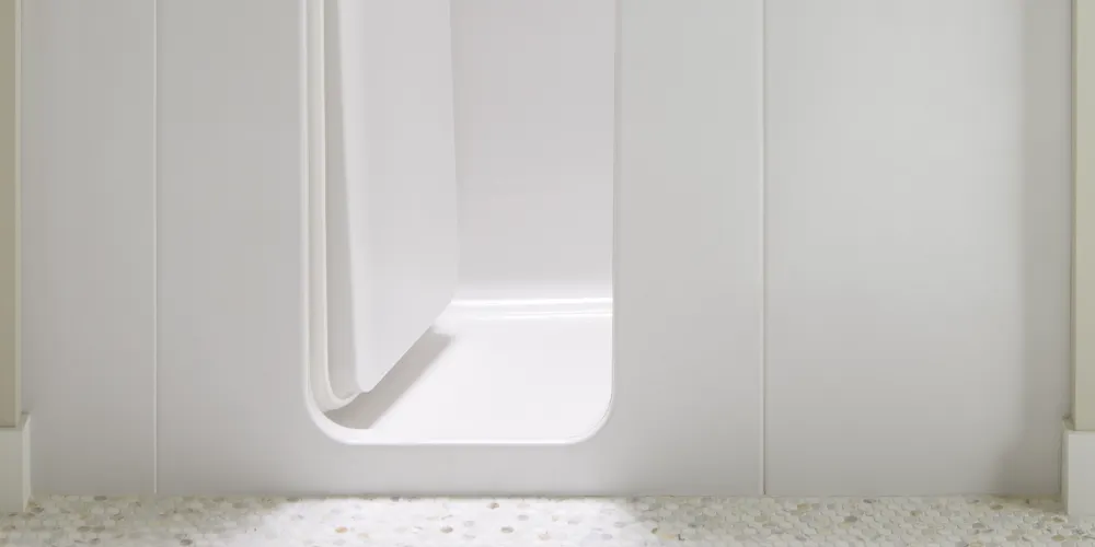 A close-up view of the ultra-low step-in threshold on a Kohler walk-in bath.