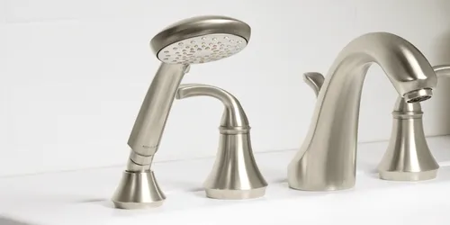 A close-up of the Kohler handshower, showcasing its ergonomic design and polished chrome finish.