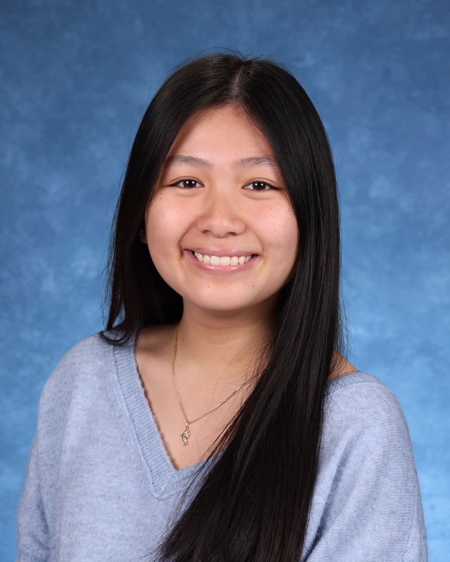 Student school directory headshot smiling with long dark hair