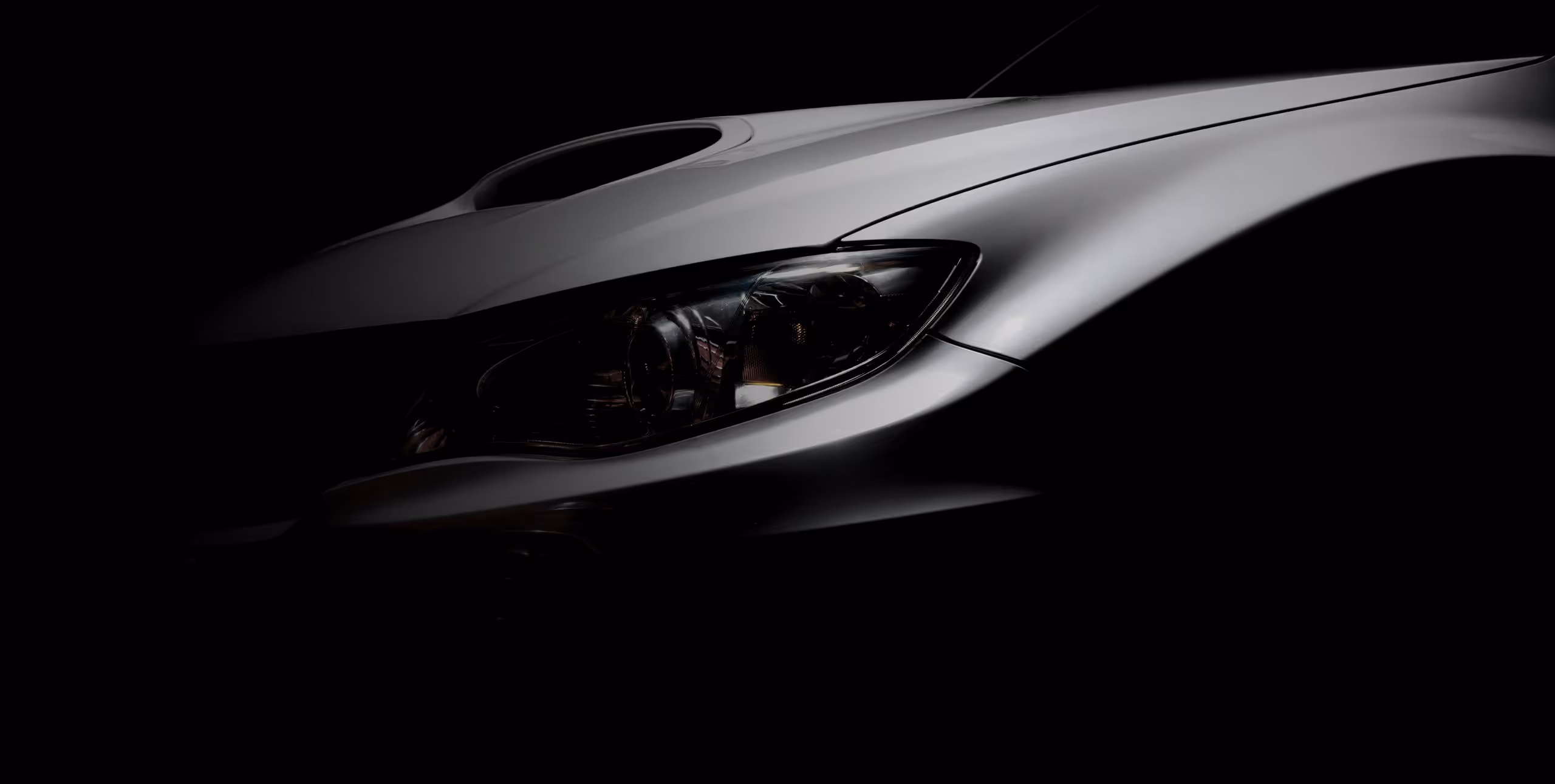 Automotive design detail with headlight and aerodynamic hood lines