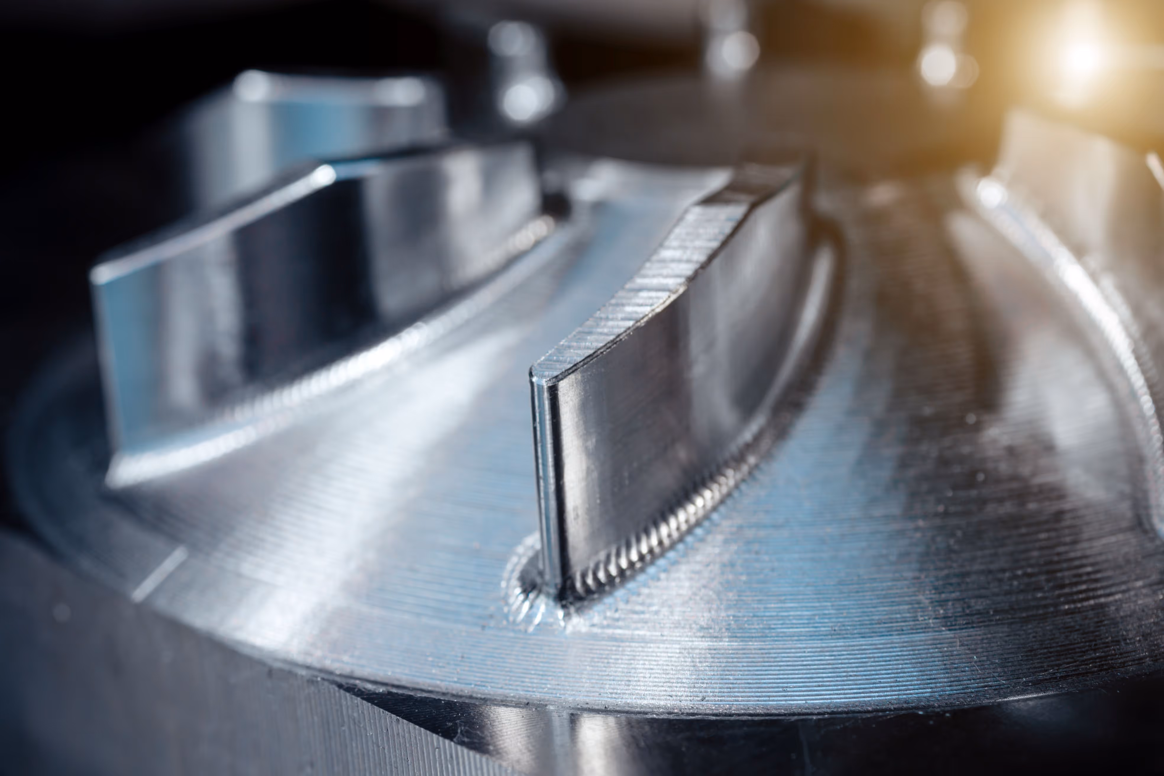 CNC machined turbine blade detail showing precision surface finish