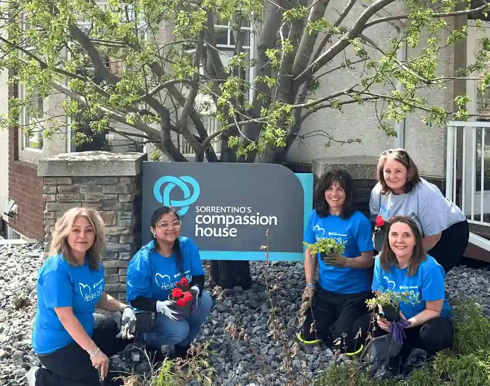 volunteers in front of the compassion house
