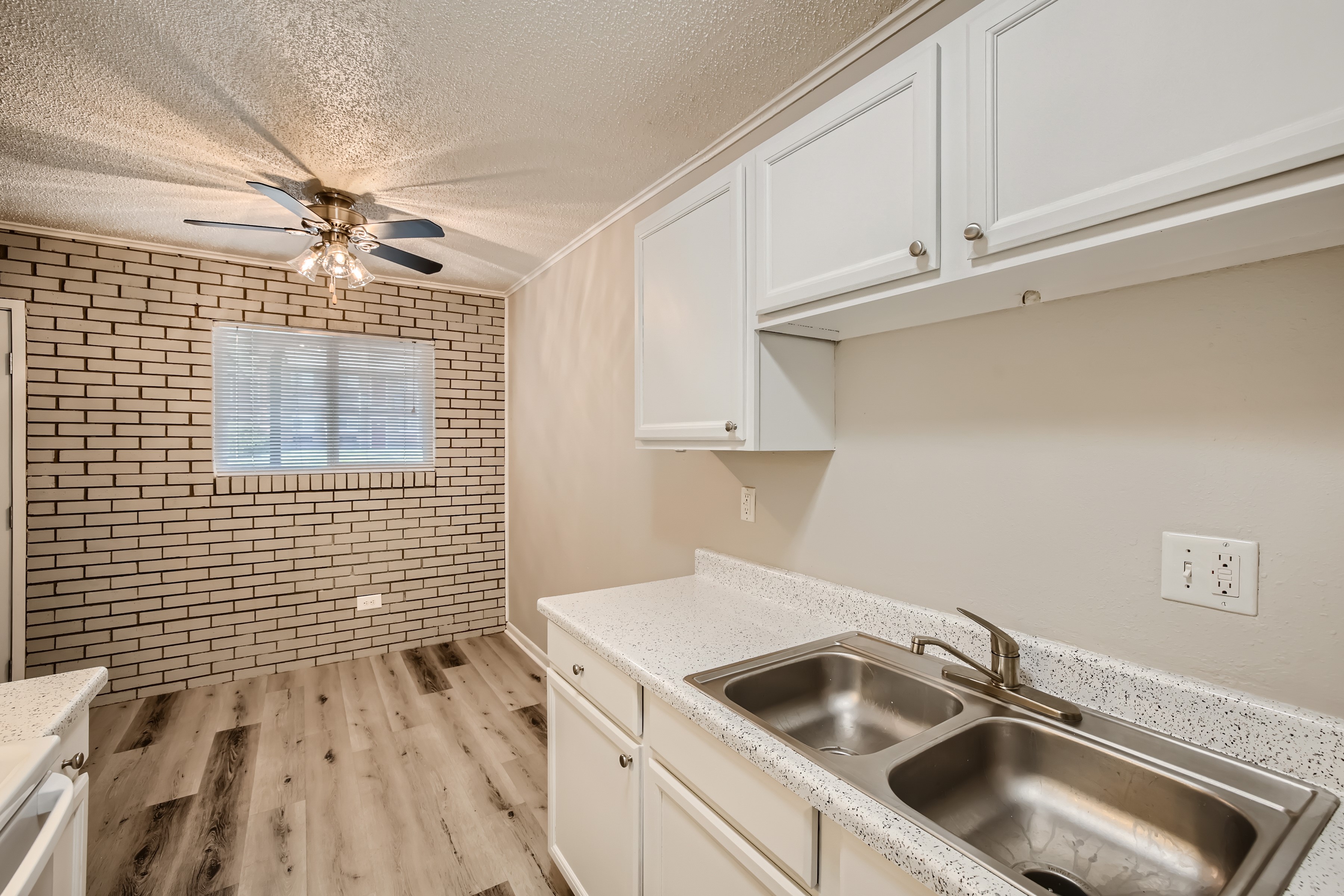 Updated Kitchen and dining room with exposed brick wall