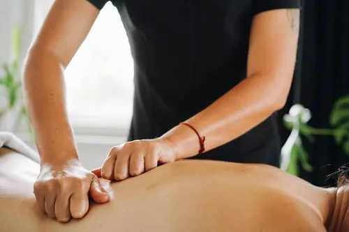 Eine Frau bekommt eine Ölmassage bei einer erfahrenen Physiotherapeutin.