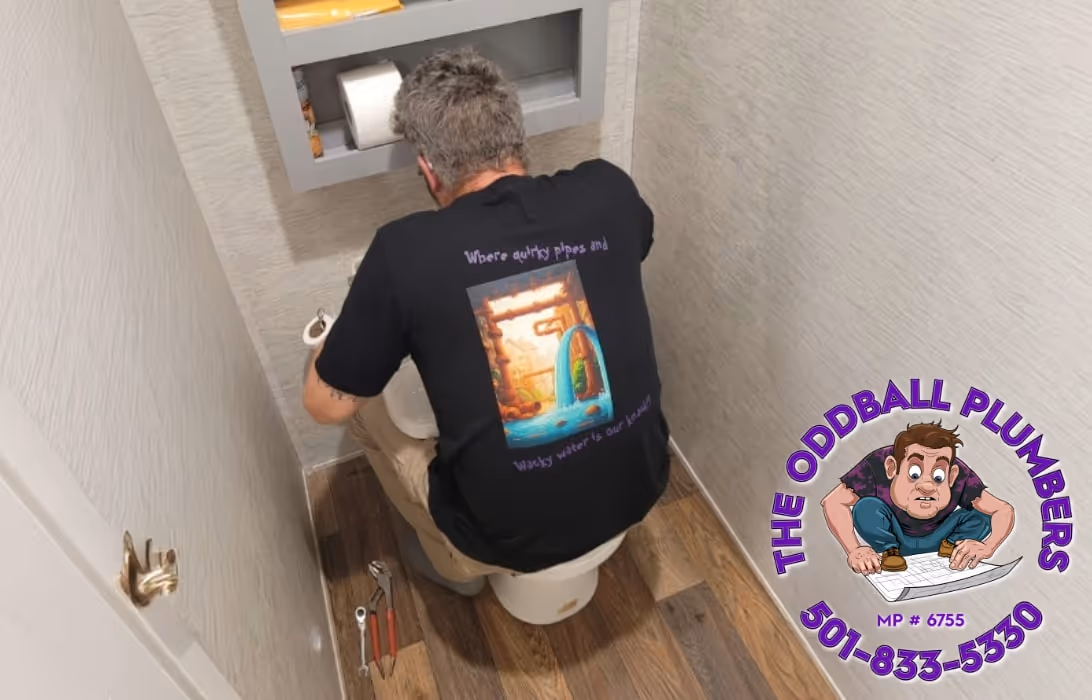 A plumber repairing a toilet.