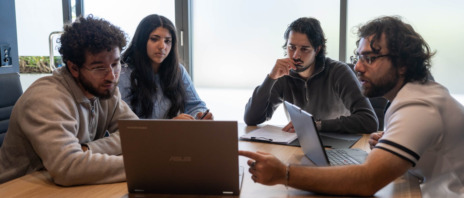 The Elevate Together team working together around the meeting table