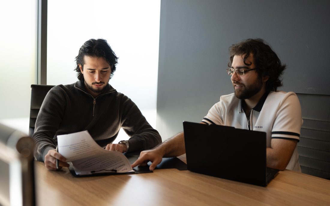 Two Elevate Together coordinators reviewing a participant's plan together