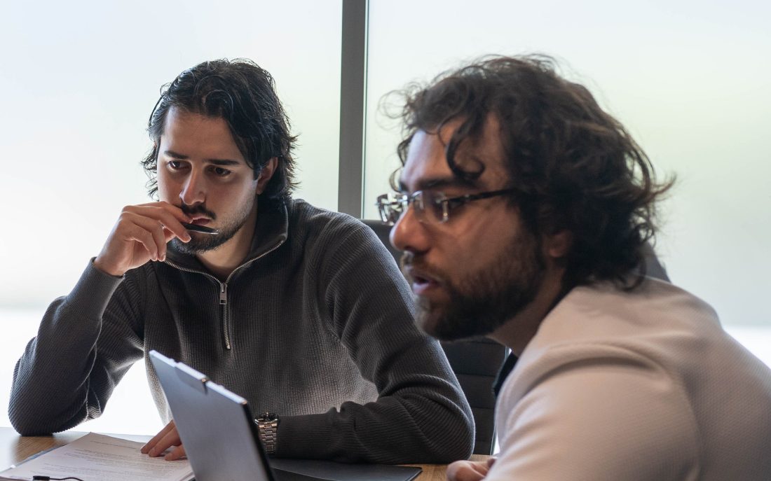 An Elevate Together advocate talking through paperwork with a client