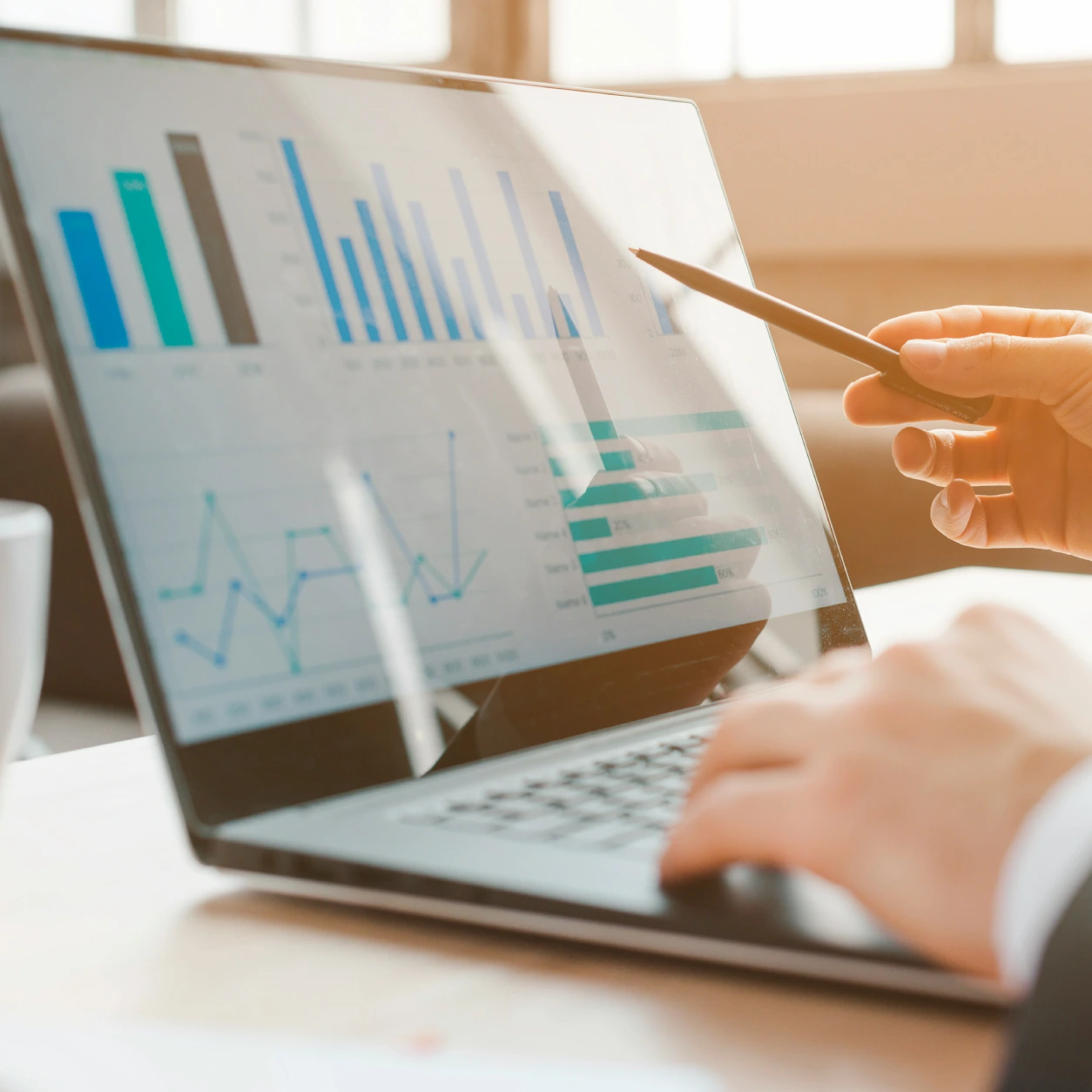 Professional analysing CRM software data on a laptop screen