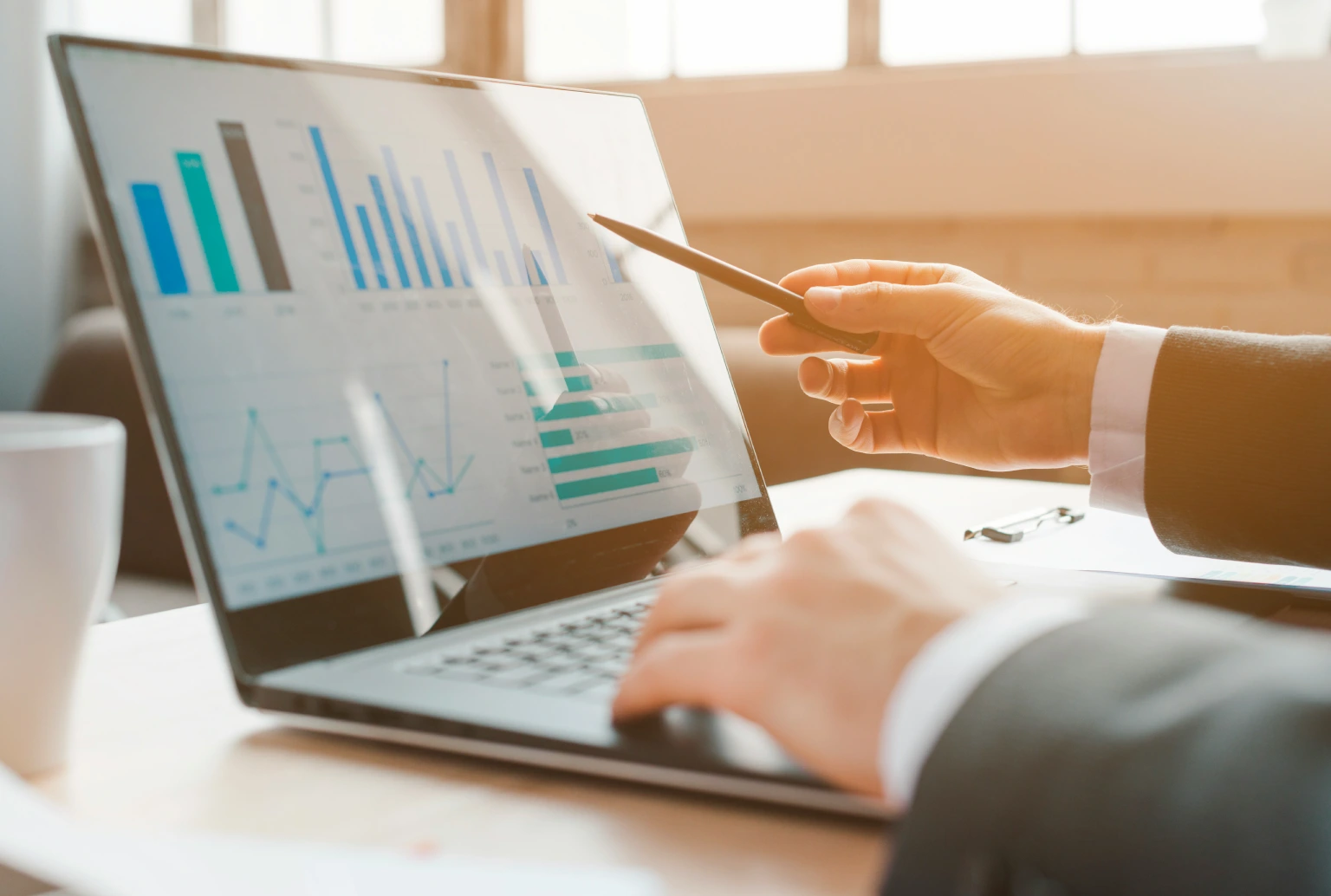 Business professional reviewing CRM data and analytics on a laptop