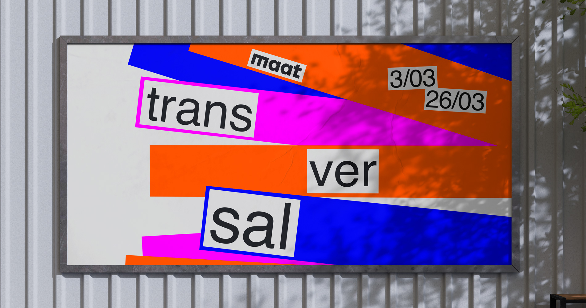 Framed colorful poster on a white wall with the words 'maat', 'trans', 'ver', and 'sal' along with dates 3/03 and 26/03 in a bold, modern design.
