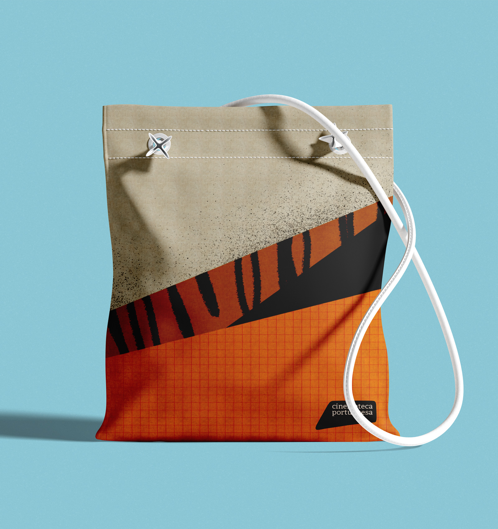 Drawstring bag with beige, orange, and black tiger stripe design and white cords on a light blue background.