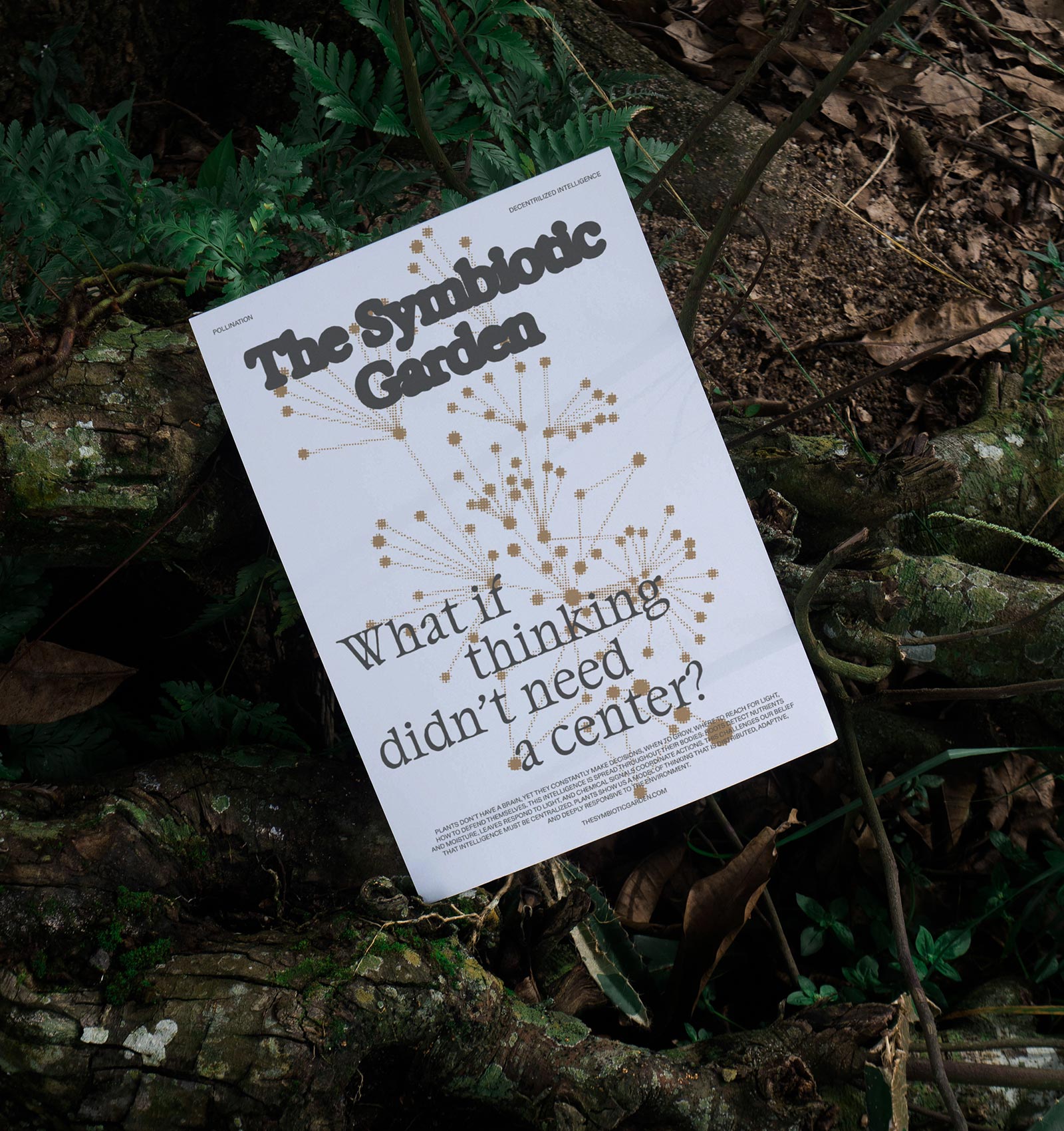 A white poster titled 'The Symbiotic Garden' with a graphic of connected dots and the question 'What if thinking didn't need a center?' placed on forest ground with leaves and branches.