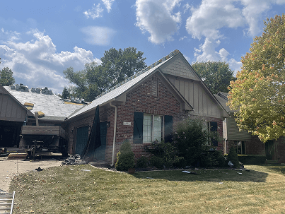 Brothers Who Roof and Construction replacing a roof on a home in a summer day