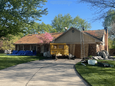 Brothers Who Roof and Construction doing a roof repair on a home during a sunny day