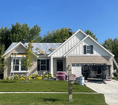 Brothers Who Roof and Construction servicing a roof with roofers.