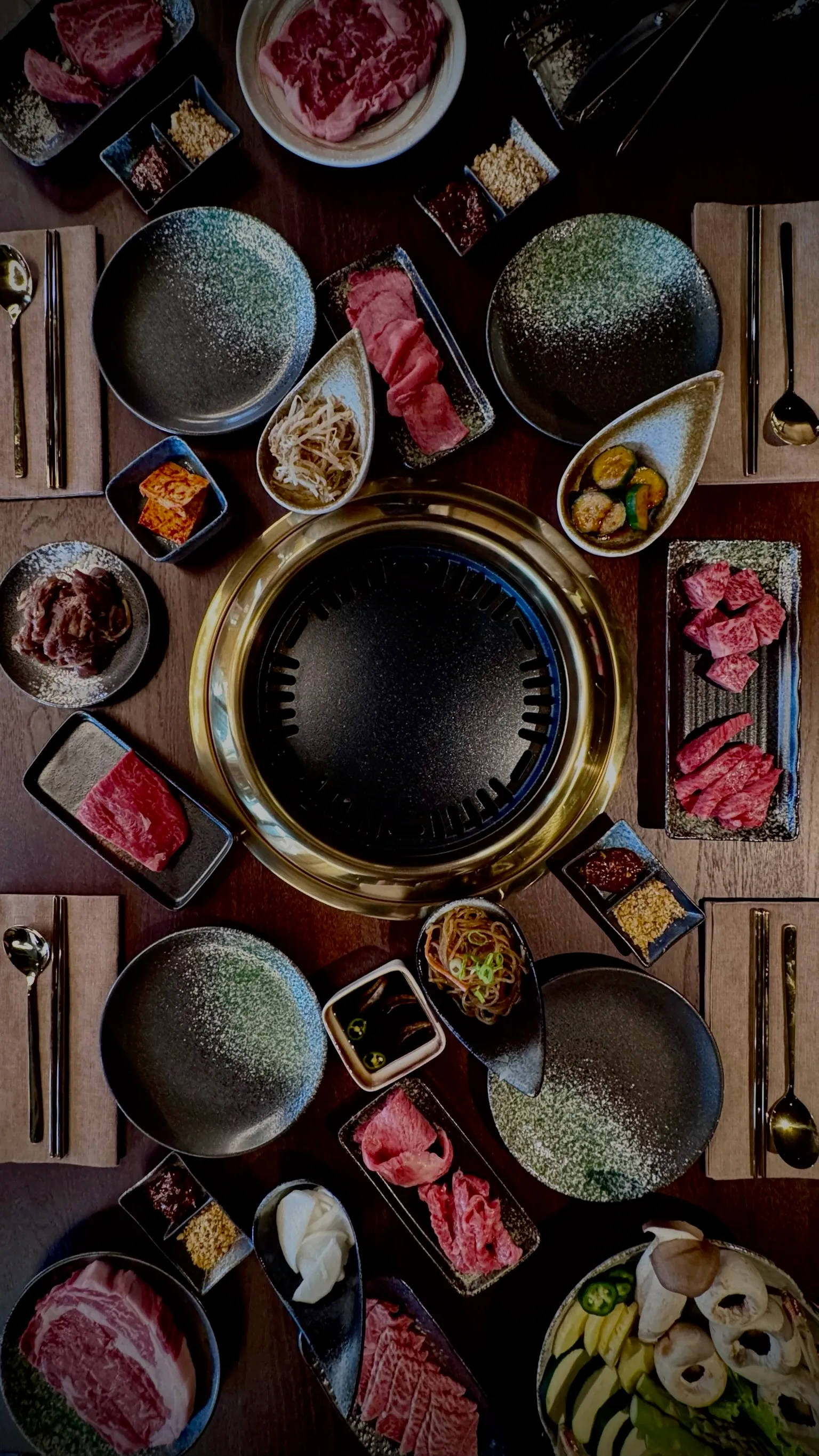 A person holding chopsticks over a plate of food.