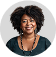 An african american woman smiling and wearing a necklace.