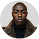 A man in a fur coat looking at the camera.
