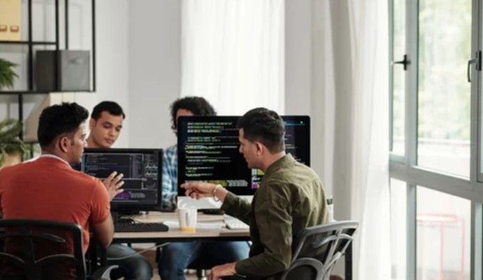 IT professionals collaborating in a managed services office, reflecting the operational systems and team structure buyers value in MSP acquisitions.